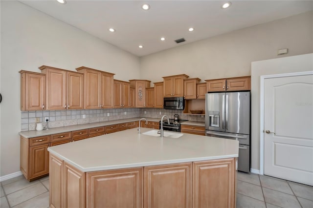 kitchen with visible vents, light tile patterned flooring, a sink, stainless steel refrigerator with ice dispenser, and black microwave