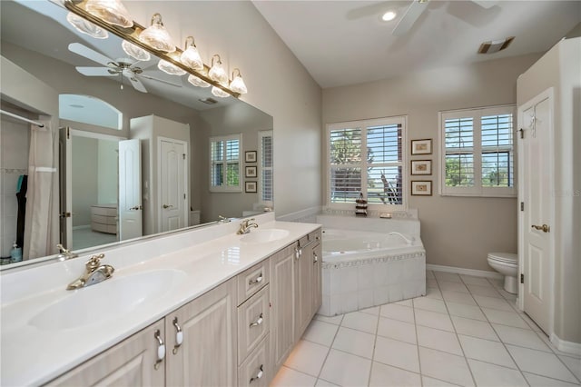 full bath with tile patterned flooring, toilet, a ceiling fan, and a sink