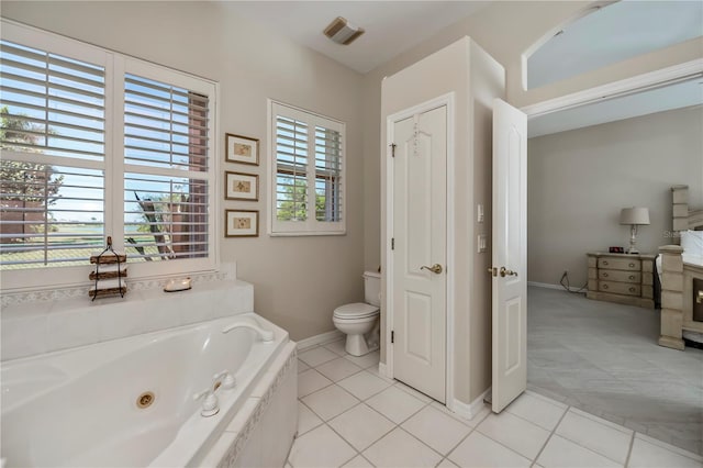 full bathroom featuring tile patterned flooring, visible vents, a jetted tub, baseboards, and toilet