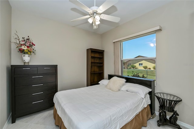 bedroom with a ceiling fan and baseboards