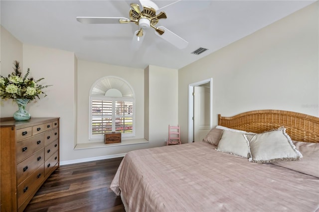 bedroom with ceiling fan, visible vents, baseboards, and dark wood-style floors