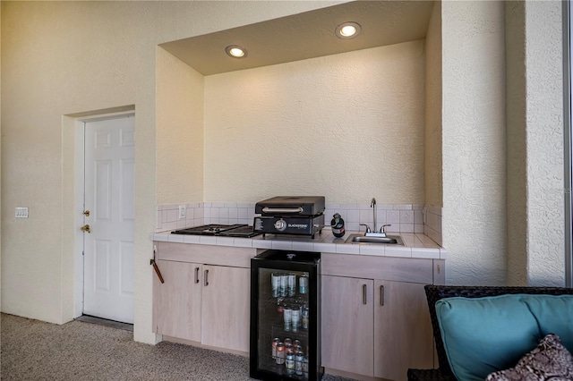 bar with recessed lighting, a sink, wine cooler, light carpet, and a textured wall