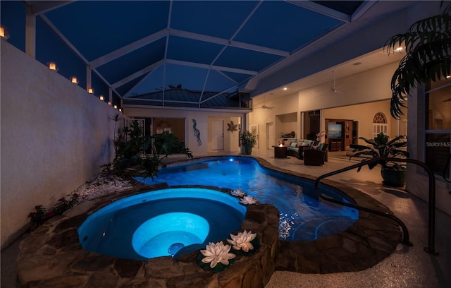 view of pool featuring a pool with connected hot tub, ceiling fan, a lanai, an outdoor hangout area, and a patio area