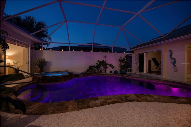 view of pool with glass enclosure, a patio, and a pool with connected hot tub