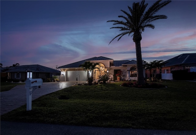 26089 Templar Ln, Punta Gorda, FL 33983 - view of front facade with a standing seam roof, metal roof, a front lawn, and driveway