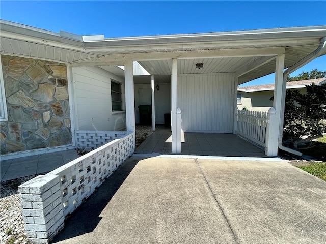 exterior space with an attached carport and concrete driveway