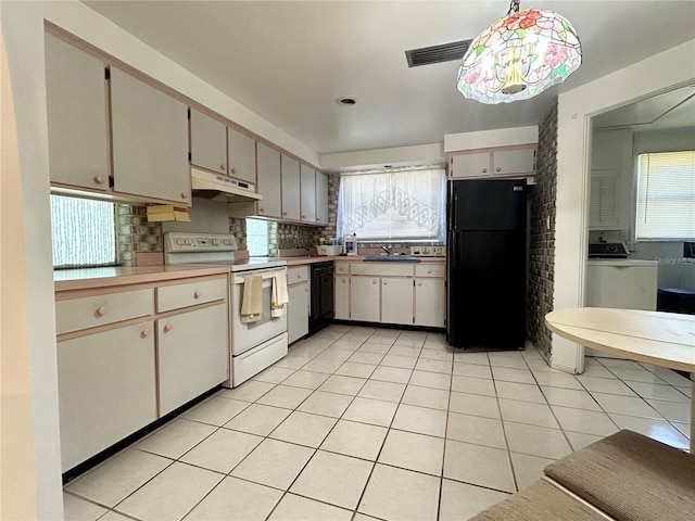 kitchen with backsplash, light tile patterned flooring, a sink, under cabinet range hood, and black appliances