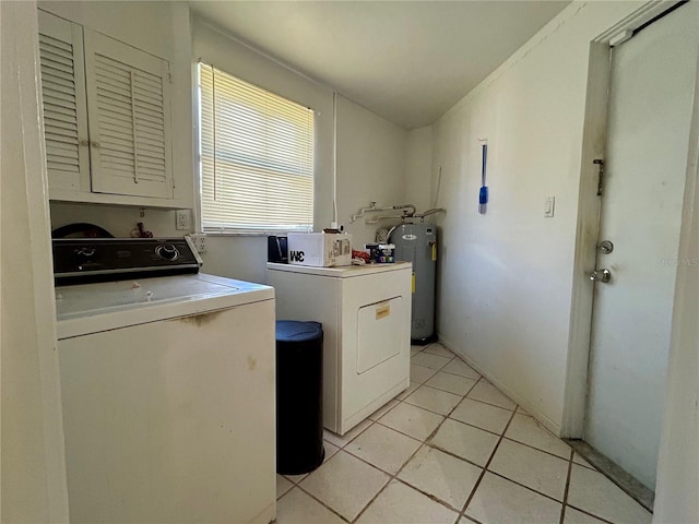 clothes washing area with laundry area, water heater, independent washer and dryer, and light tile patterned flooring