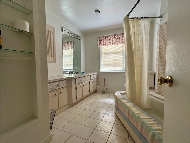 bathroom with baseboards, shower / bath combo with shower curtain, vanity, and tile patterned floors