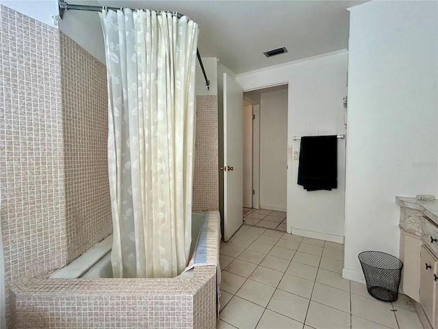 bathroom with tiled shower / bath combo, tile patterned flooring, visible vents, and vanity