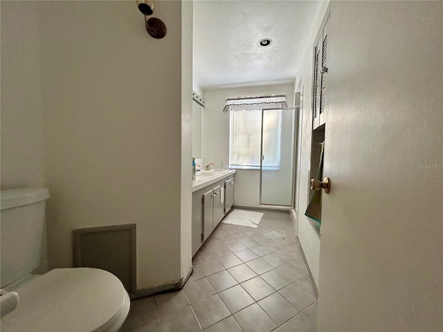 full bath with vanity, toilet, and tile patterned floors