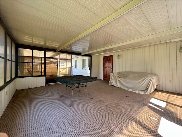 unfurnished sunroom with beamed ceiling