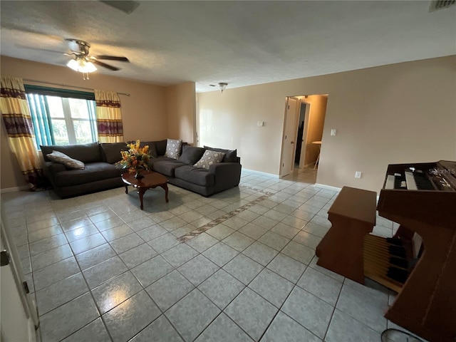 living area with light tile patterned flooring, visible vents, and baseboards