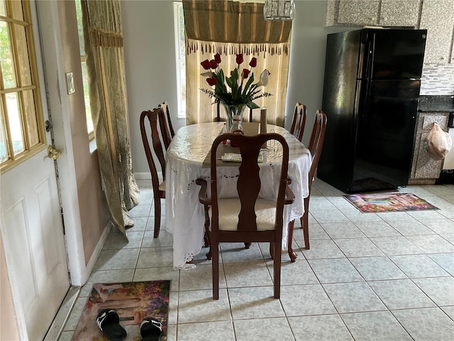 dining area with baseboards and light tile patterned floors