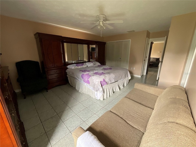 bedroom featuring ceiling fan, a closet, and light tile patterned flooring