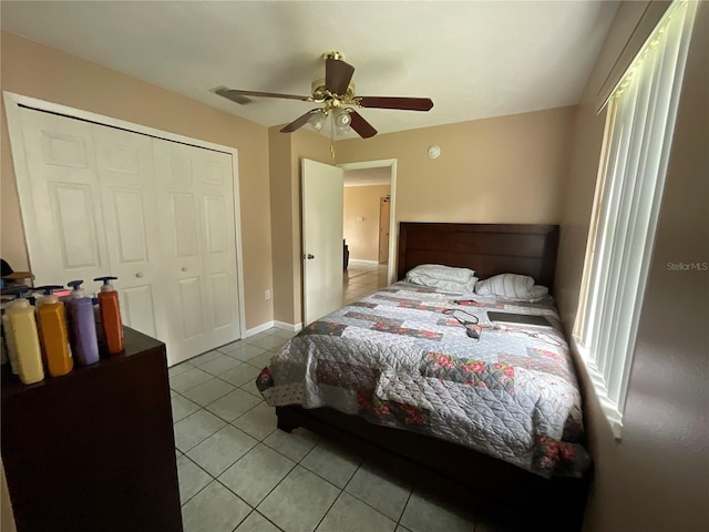 tiled bedroom featuring a ceiling fan, a closet, and visible vents