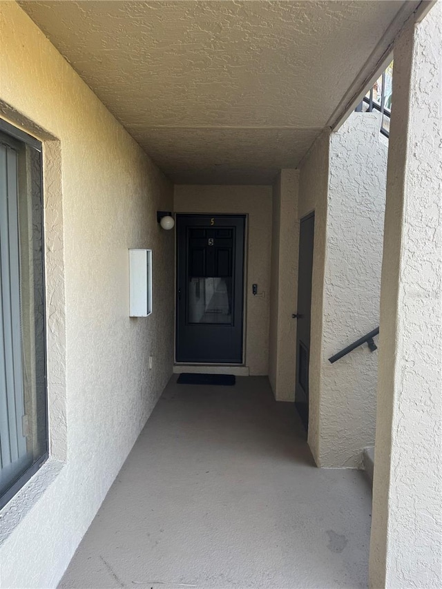 property entrance with stucco siding