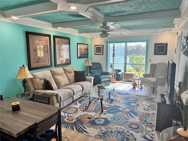 living area with ceiling fan, coffered ceiling, wood finished floors, beam ceiling, and crown molding