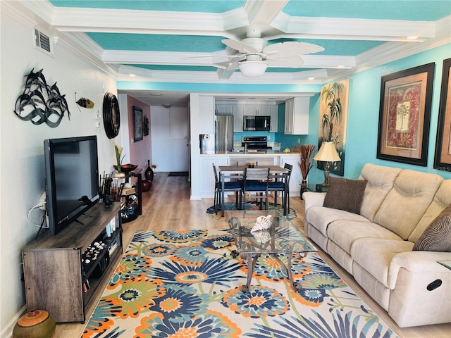 living area featuring beam ceiling, crown molding, visible vents, light wood-type flooring, and coffered ceiling