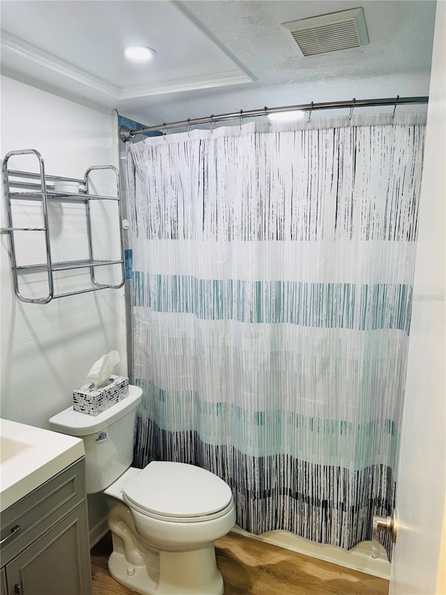 bathroom with a shower with shower curtain, visible vents, vanity, and toilet