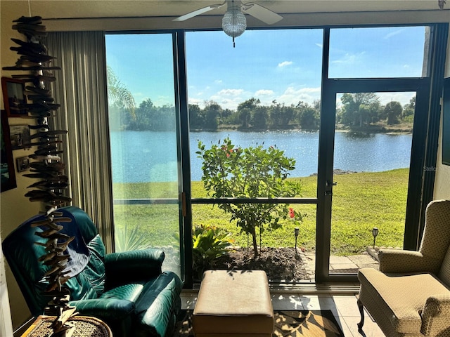 sunroom with a water view and a ceiling fan