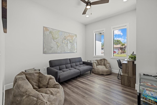 living area with a ceiling fan, baseboards, wood finished floors, and recessed lighting