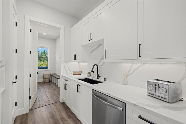 kitchen featuring a sink, dark wood-style floors, white cabinetry, and dishwasher