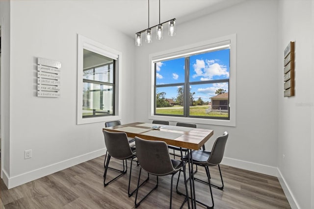 dining space with dark wood-style floors and baseboards