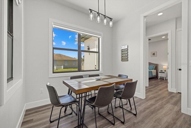 dining room with recessed lighting, baseboards, and wood finished floors