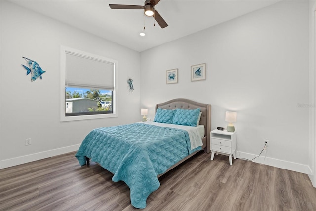 bedroom featuring a ceiling fan, recessed lighting, baseboards, and wood finished floors