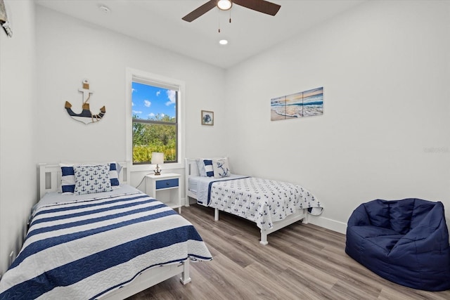 bedroom featuring a ceiling fan, recessed lighting, baseboards, and wood finished floors