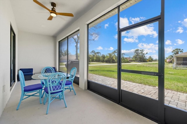 sunroom featuring ceiling fan