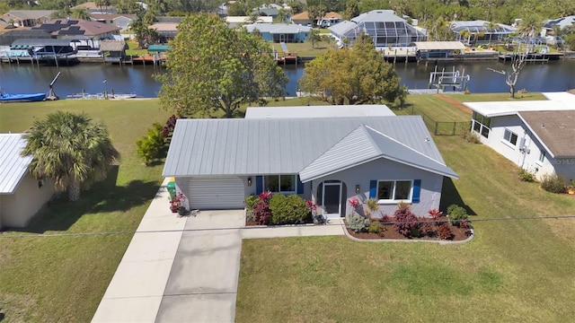 drone / aerial view featuring a water view and a residential view