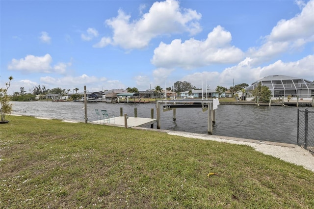 view of dock with a yard and a water view