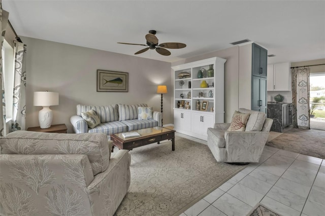 living room with marble finish floor, visible vents, and a ceiling fan