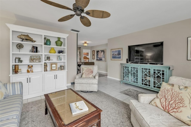 tiled living area with visible vents, baseboards, and a ceiling fan