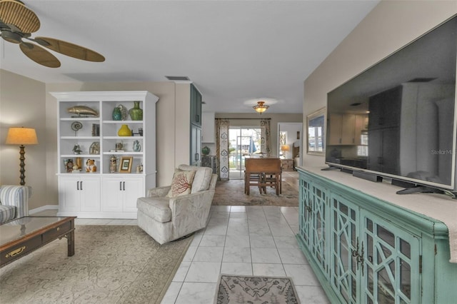 living room with visible vents and a ceiling fan