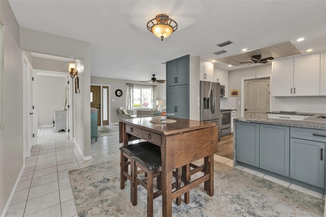 kitchen featuring light tile patterned floors, visible vents, appliances with stainless steel finishes, light stone countertops, and recessed lighting