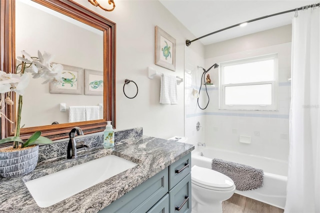 full bathroom featuring wood finished floors, vanity, toilet, and shower / bath combo with shower curtain