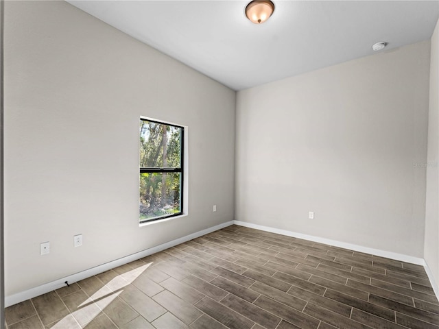 spare room with wood finish floors and baseboards