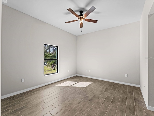 empty room with baseboards, a ceiling fan, and wood finished floors