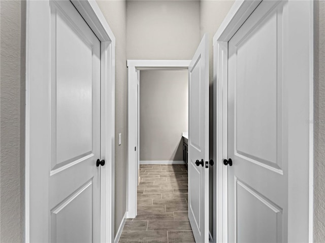 hall with wood tiled floor and baseboards