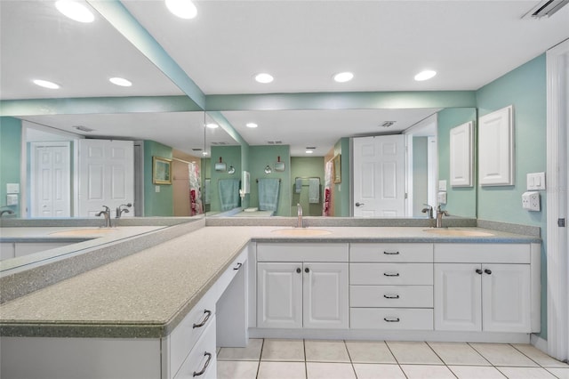 full bath featuring a sink, visible vents, double vanity, and tile patterned flooring