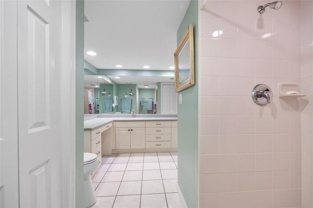 bathroom featuring vanity, recessed lighting, a tile shower, tile patterned floors, and toilet