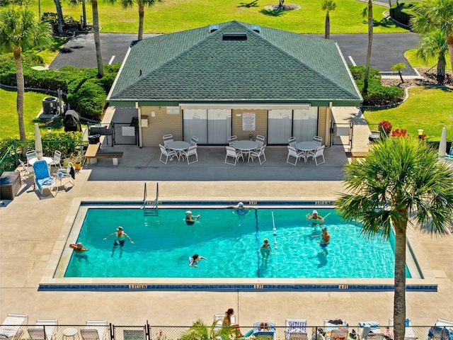 community pool featuring a patio and fence