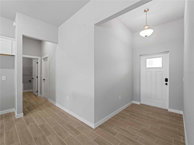 foyer with wood finish floors and baseboards