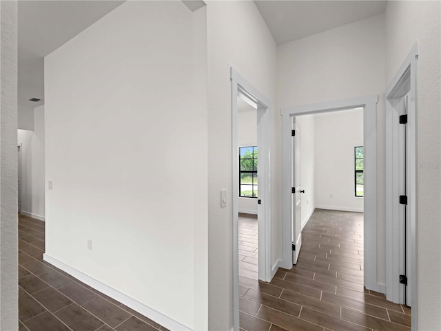 12156 Wellington Ave, Port Charlotte, FL 33981 - corridor with baseboards and dark wood-style flooring