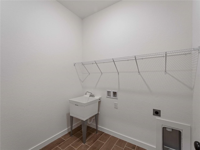 12156 Wellington Ave, Port Charlotte, FL 33981 - washroom with hookup for a washing machine, baseboards, hookup for an electric dryer, and wood finish floors