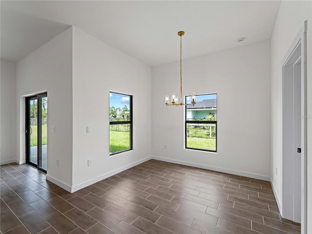 12156 Wellington Ave, Port Charlotte, FL 33981 - unfurnished dining area with a chandelier, baseboards, and dark wood finished floors