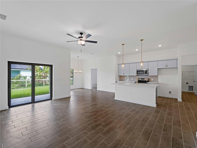 12156 Wellington Ave, Port Charlotte, FL 33981 - kitchen with appliances with stainless steel finishes, open floor plan, light countertops, baseboards, and ceiling fan